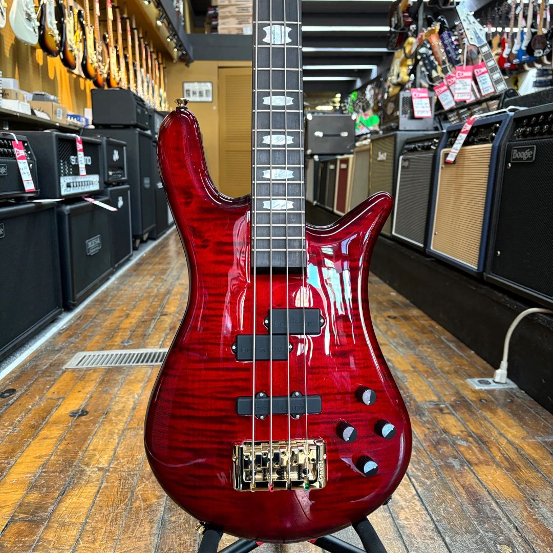 Close up front view of Spector Euro 4 LT Bass Guitar Red Fade Gloss in music store