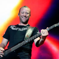 Mike Kroeger playing Spector MK-5 Pro Mike Kroeger Signature Bass Guitar on stage with colorful backdrop