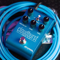Angled view of Strymon Cloudburst on top of blue cable and amplifier