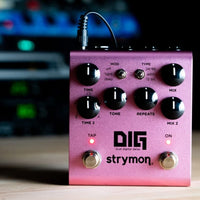 Front view of Strymon DIG on wooden surface with studio background