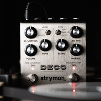 Front view of Strymon Deco on black background with tape reels in the foreground