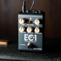 Angled front view of Strymon EC-1 on top of amplifier with brown background