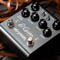 Angled view of front panel of Strymon El Capistan on top of tape reels on grey surface