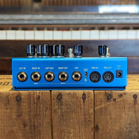 Rear view of Strymon Mobius on top of wooden surface with piano background