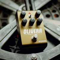 Angled front view of Strymon Olivera Vintage Oil Can Echo Pedal on metal gear