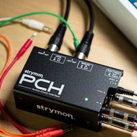 Top view of Strymon PCH with cables attached on top of wooden surface
