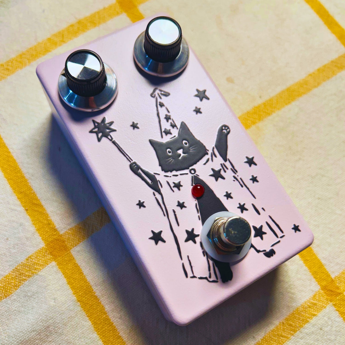 Angled view of TONECAT PurrMancer Vintage Analog Chorus Pedal on beige cloth with yellow stripes