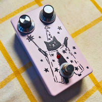 Angled view of TONECAT PurrMancer Vintage Analog Chorus Pedal on beige cloth with yellow stripes