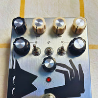 Close up front view of TONECAT Vanishing Tail Analogue PLL Synth Fuzz Pedal on beige cloth with yellow stripes