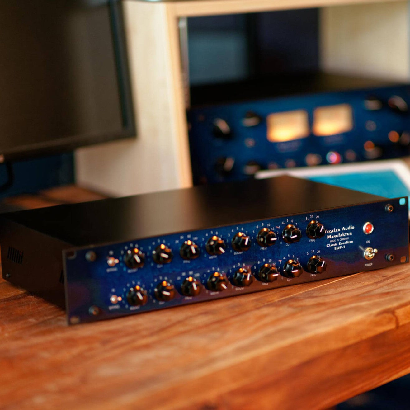 Angled view of Tegeler Classic Equalizer EQP-1 Passive Tube Equalizer on wooden desk in studio