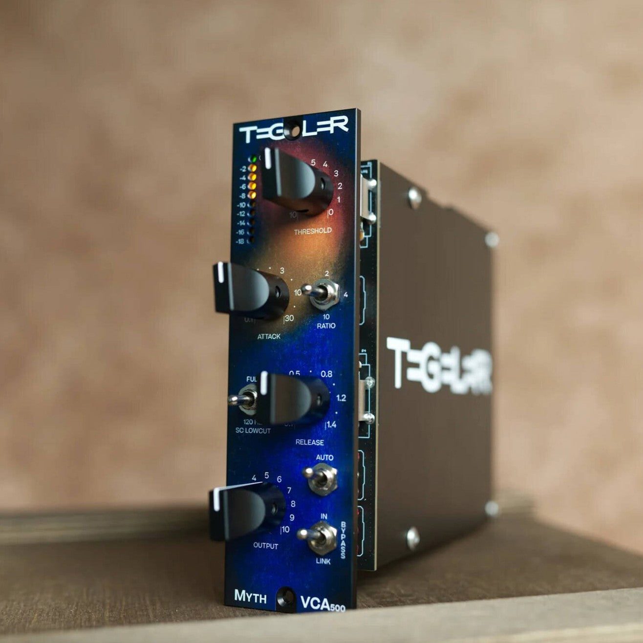 Angled view of Tegeler MythVCA 500 VCA Compressor on top of wooden surface in room