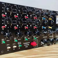 Close up angled shot of black rackmount effect on top of wooden table on gray background