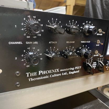Close up of front panel of Thermionic Culture Phoenix Mastering Plus on desk with studio background