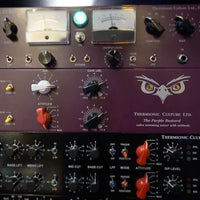 Close up photo of purple rackmount effects on top of black rackmount effects on a rack