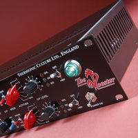 Close-up shot of black rackmount effect on a red table with red background