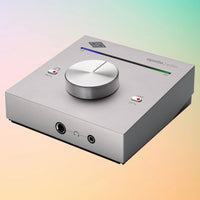 Angled view of Universal Audio Apollo e2m Stereo Headphone Amp and Line Interface on orange and green gradient background