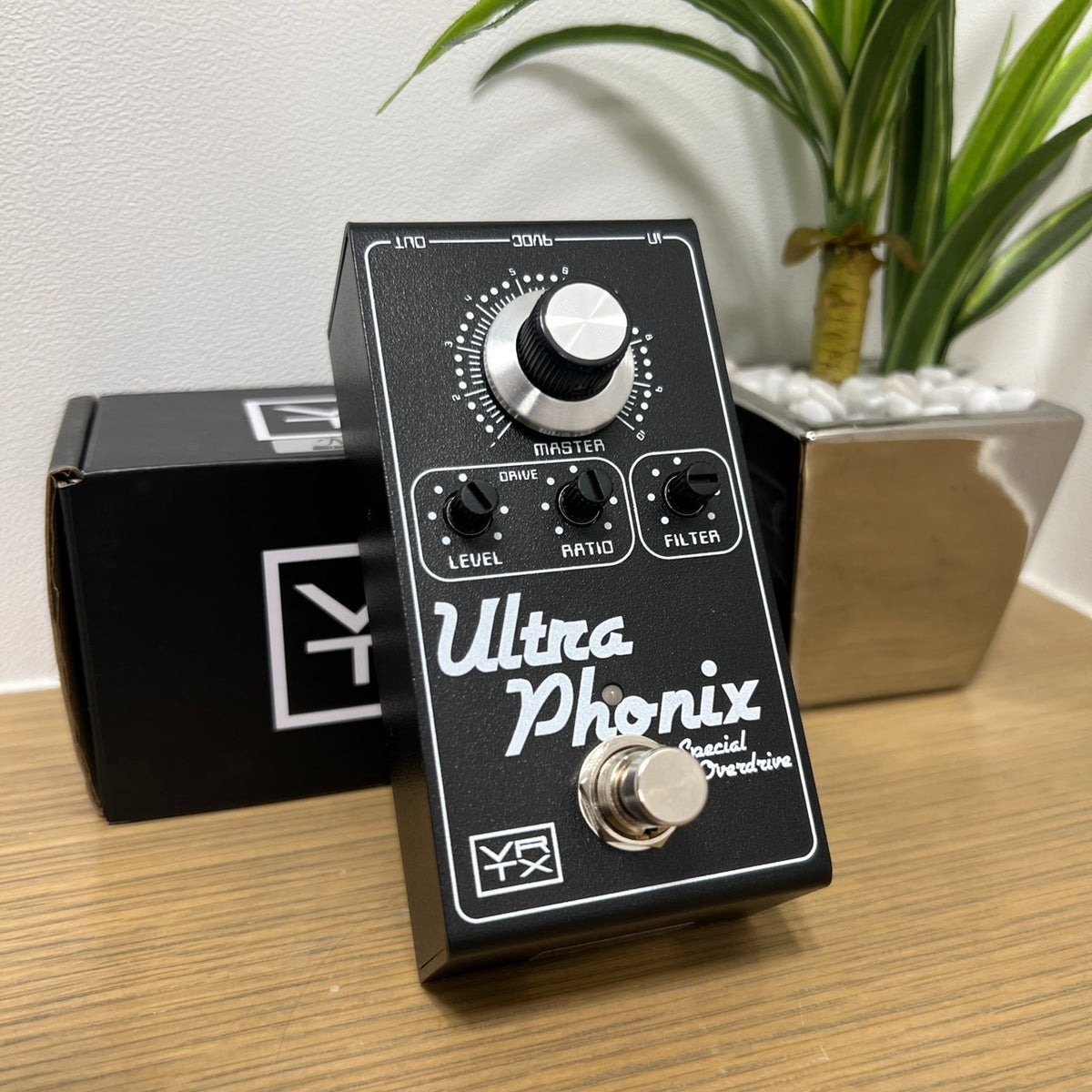 Angled view of Vertex Effects Ultraphonix MKII Pedal leaning on box on wooden surface