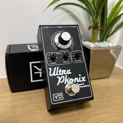 Angled view of Vertex Effects Ultraphonix MKII Pedal leaning on box on wooden surface