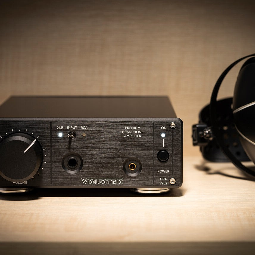 Front view of Violectric HPA V202 Headphone Amplifier on wooden surface