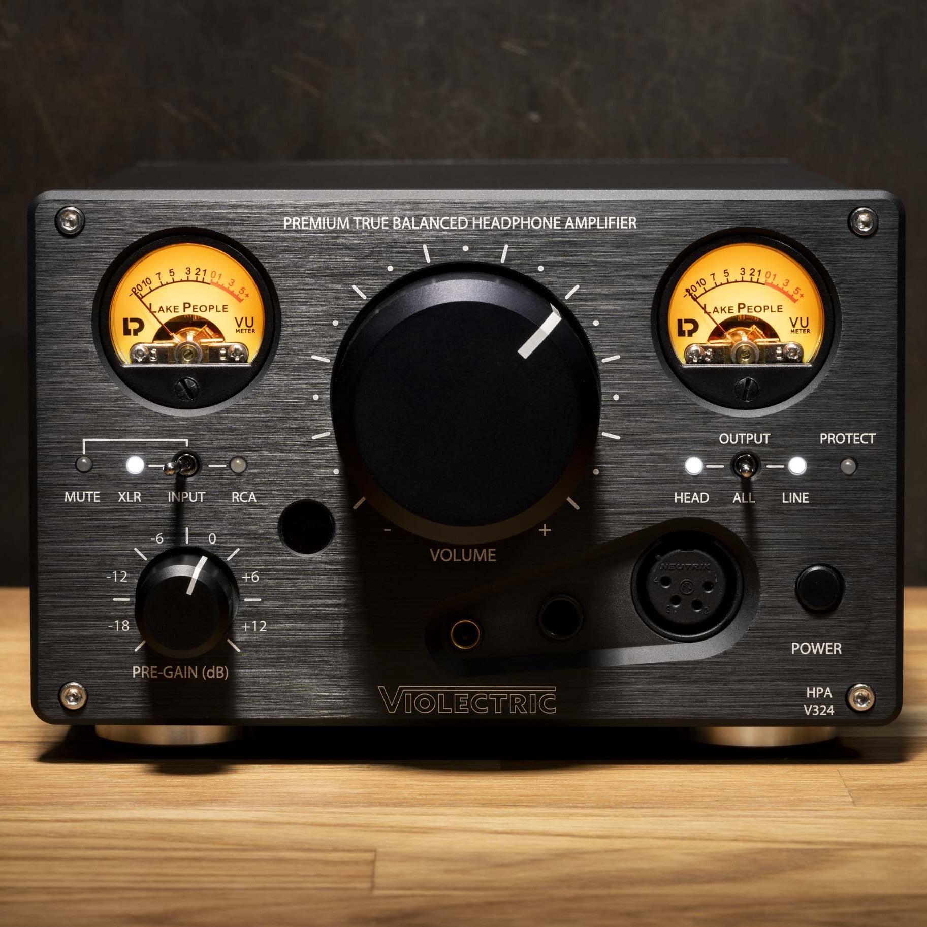Front view of Violectric HPA V324 Headphone Amplifier on wooden surface
