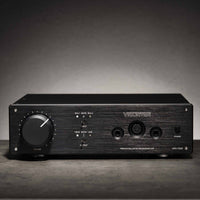 Front view of Violectric HPA V340 Headphone Amplifier on grey concrete surface