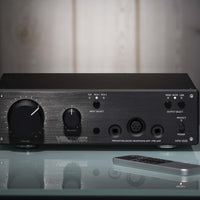 Front view of Violectric HPA V550 Headphone Amplifier on glass surface