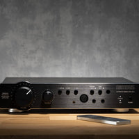 Front view of Violectric Niimbus US 5 Headphone Amplifier on top of wooden surface