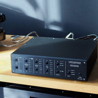 Angled front view of Violectric PPA V790 Phono Preamplifier on top of wooden console