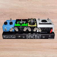 Front view of Voodoo Lab Dingbat TINY Pedalboard with pedals attached on wooden background