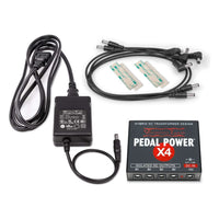 Front view of Voodoo Lab Pedal Power X4 with included cables and accessories on white background