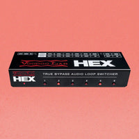 Angled front view of Voodoo Lab HEX True Bypass 6-Loop Audio Switcher on peach background