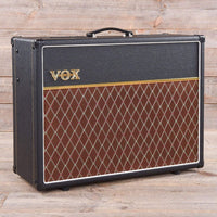 Angled front view of Vox AC30 OneTwelve Electric Guitar Amplifier on wooden surface with wooden background