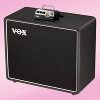 Angled front view of Vox BC112 1x12" Speaker Cabinet with Vox MV50 on it on pink background