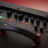 Close up view of Vox VT100X Modeling Electric Guitar Amplifier controls with red background