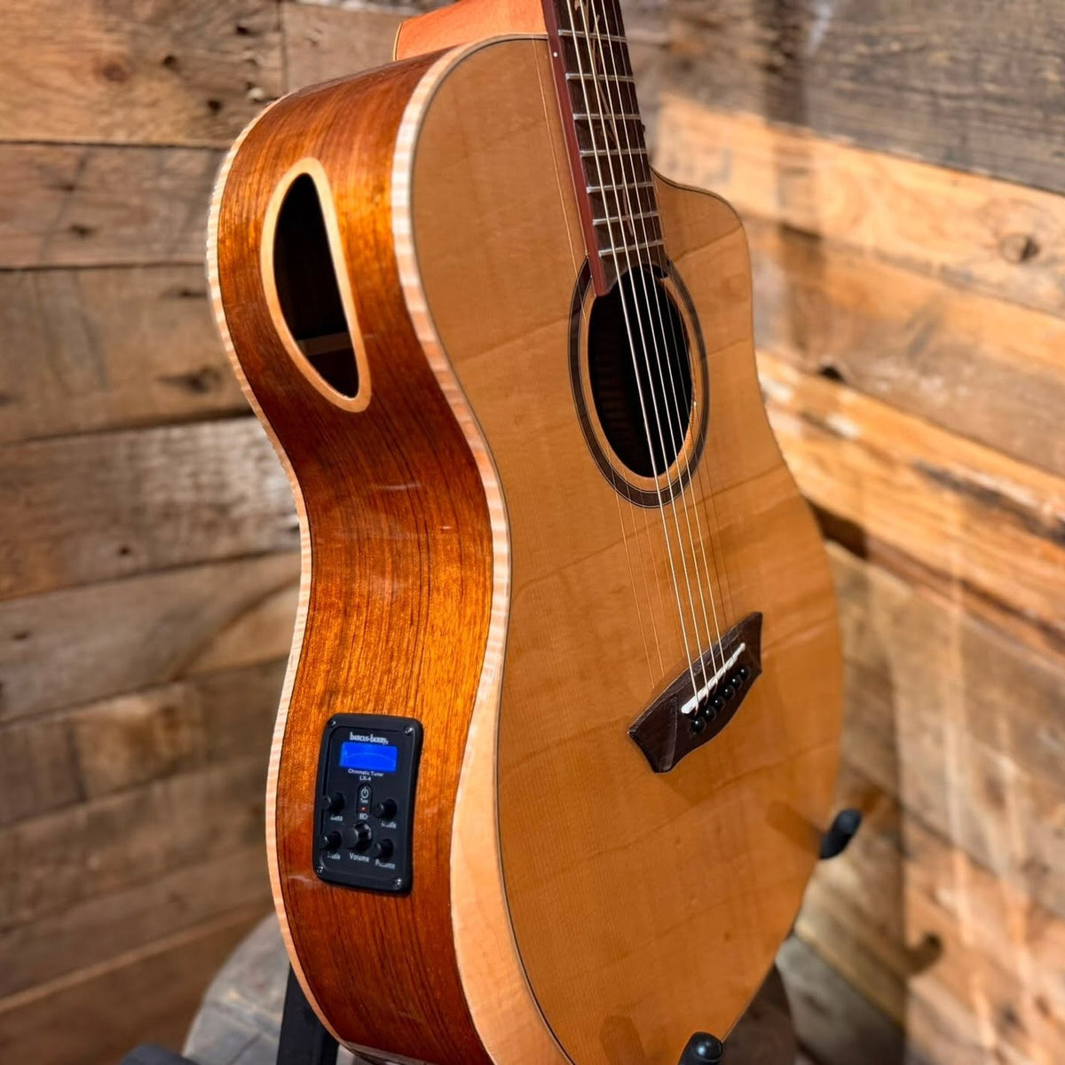 Close up angled view of Washburn BTSC40SCE Bella Tono Suprema Acoustic Electric Guitar on wooden background