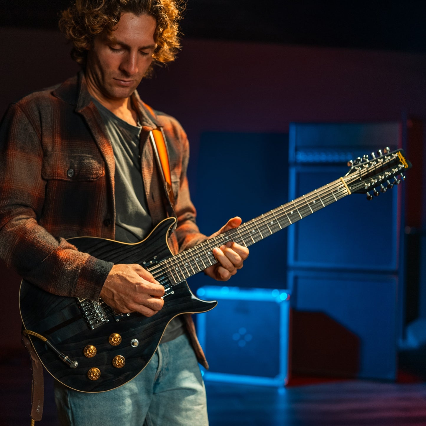 Guitarist playing the Washburn Hawk 12-String Electric Guitar (Trans Black) in studio