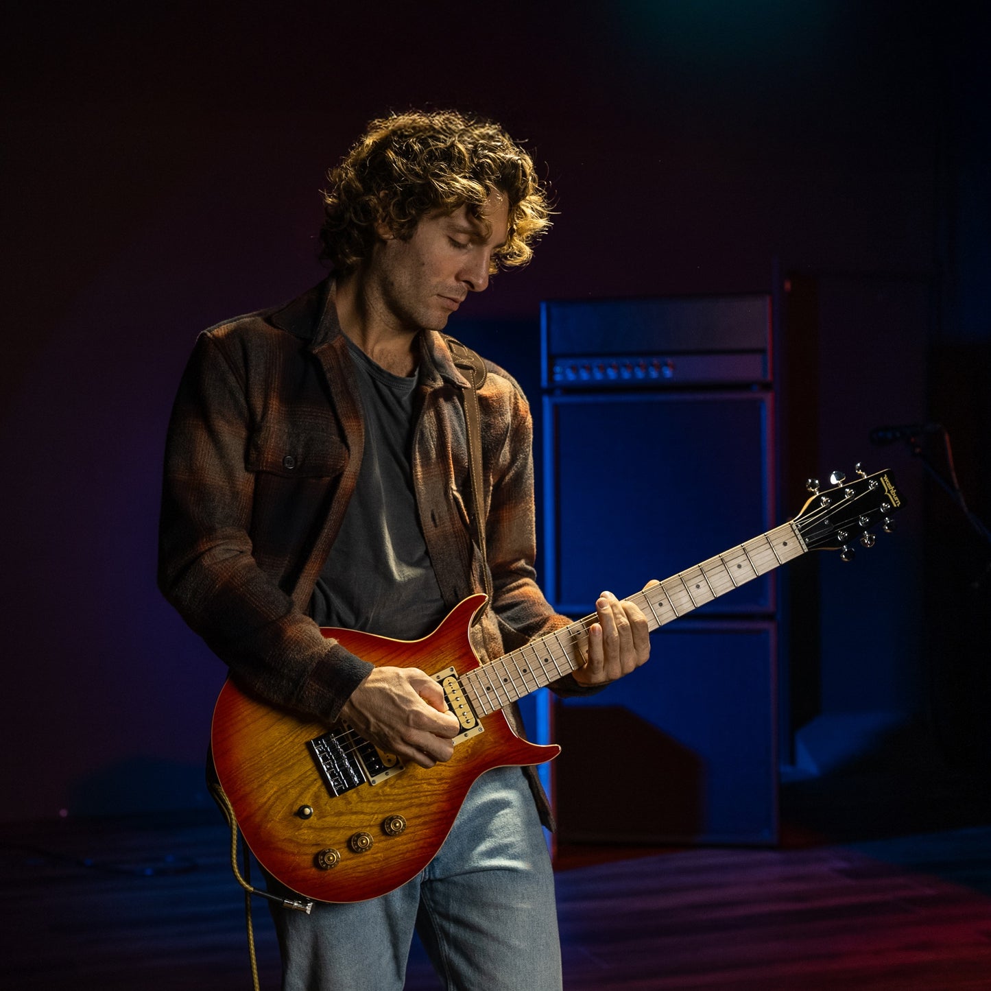 Guitarist playing the Washburn Raven Electric Guitar Cherry Burst in studio