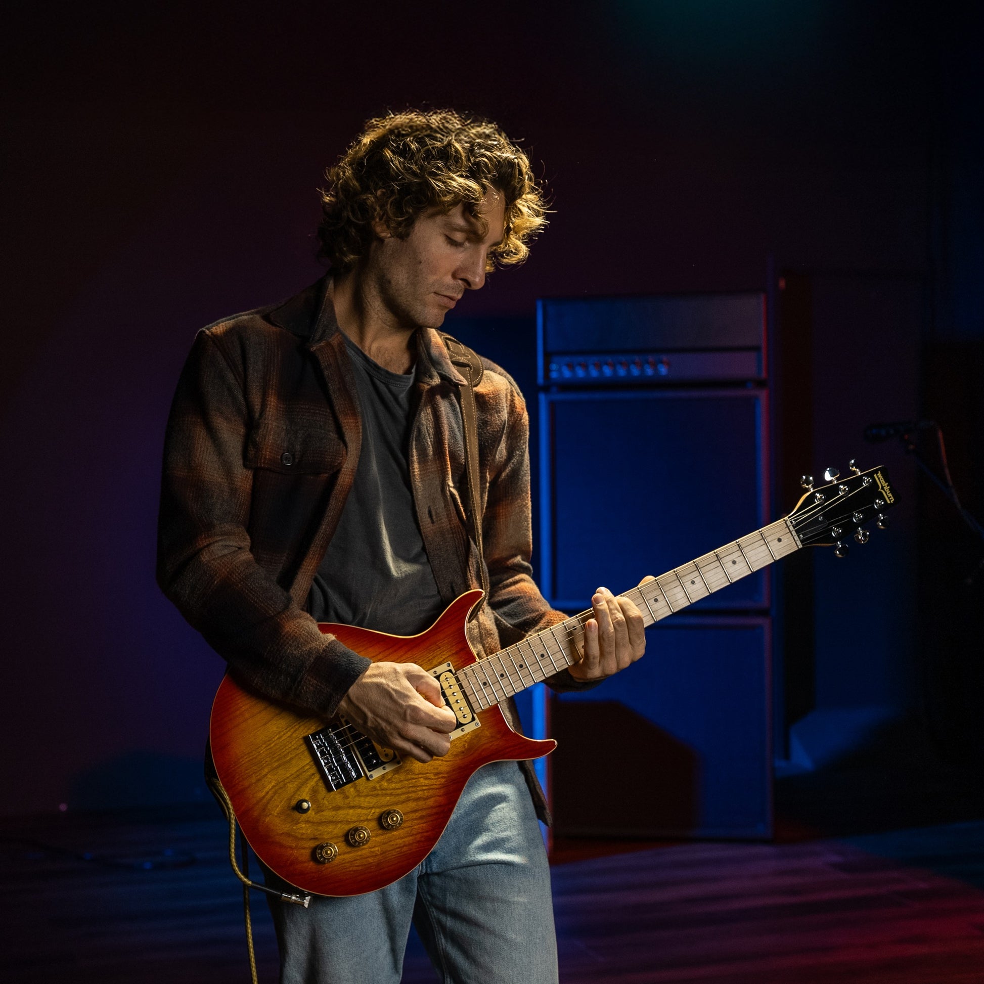 Guitarist playing the Washburn Raven Electric Guitar Cherry Burst in studio