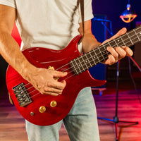 Bassist playing the Washburn Scavenger Bass Guitar Trans Red in studio
