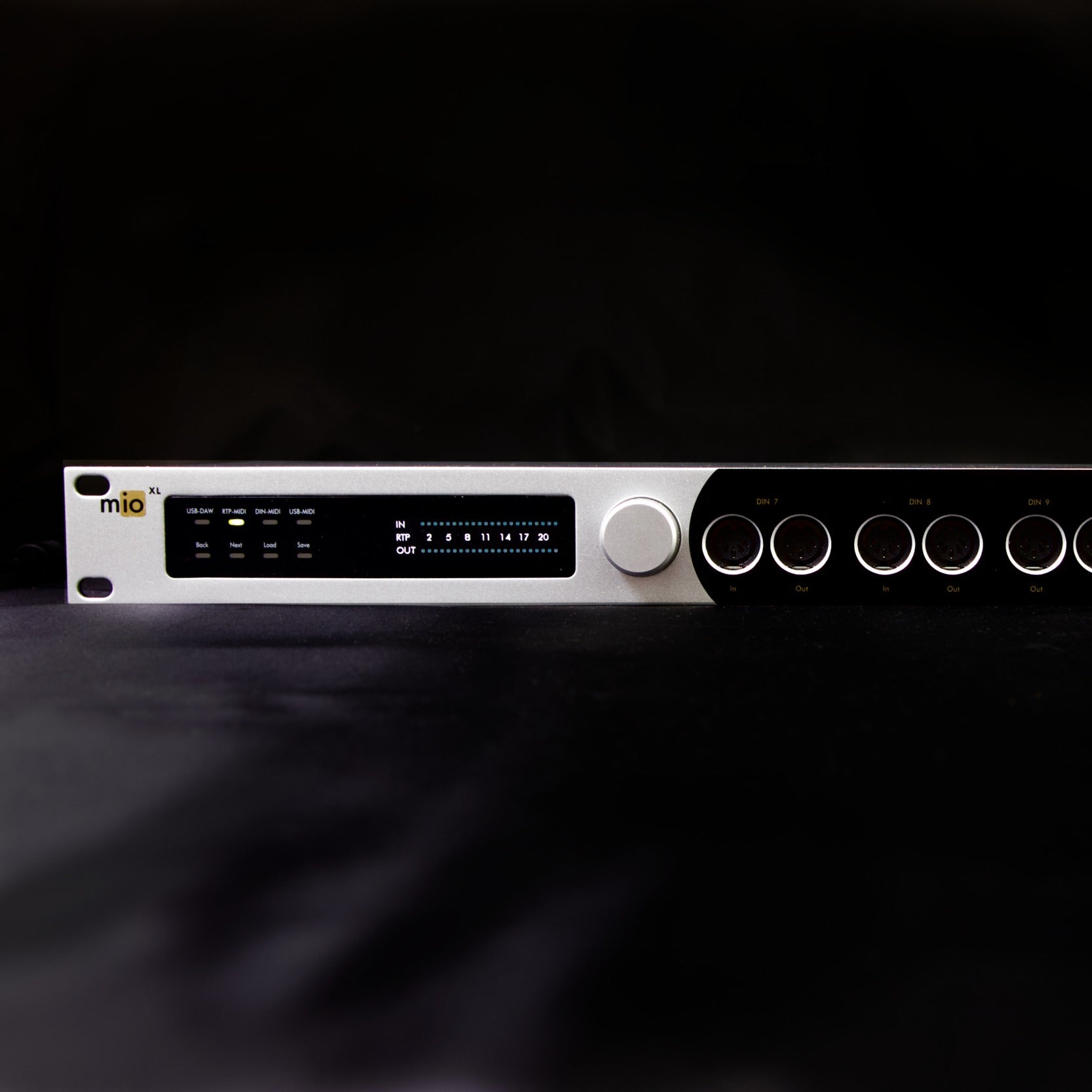 Close up front view of iConnectivity mioXL MIDI Interface on black surface