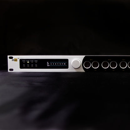 Close up front view of iConnectivity mioXL MIDI Interface on black surface